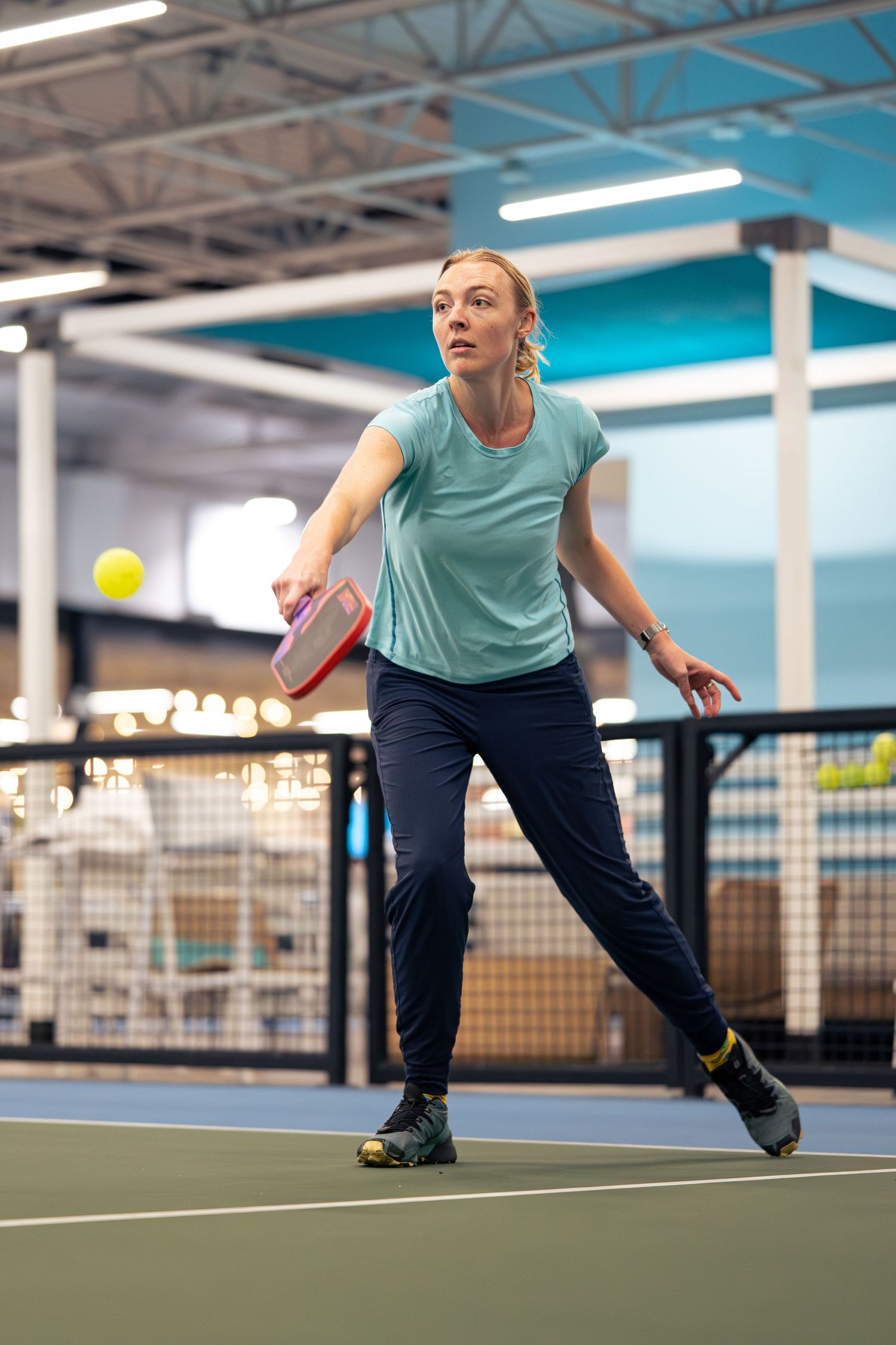 A pickleball player returns a volley at an indoor venue in Chicago