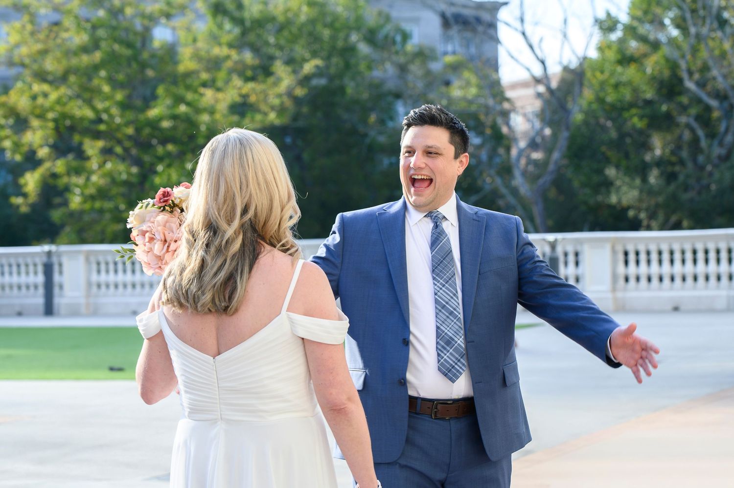 Wedding couple shares joyful moments during outdoor photo session in garden setting with white balustrade. wedding photos in alpharetta, GA