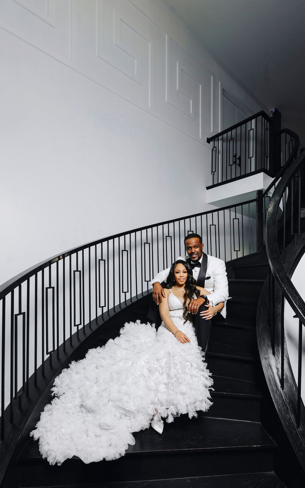 A dramatic photo sequence on dark stairs featuring flowing white formal dress movements against black railings.