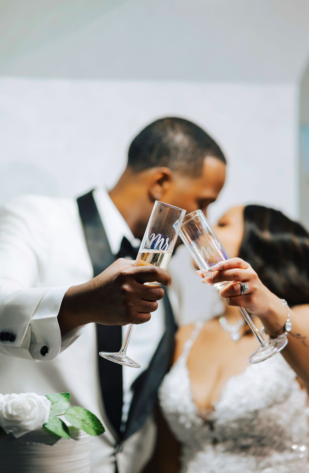 Close-up of wedding couple toasting with champagne glasses.
