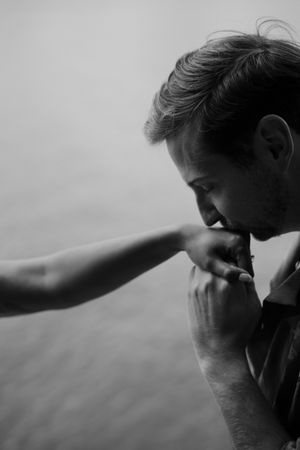A black and white photo series shows someone wiping their eyes and face in a sequence of emotional moments.