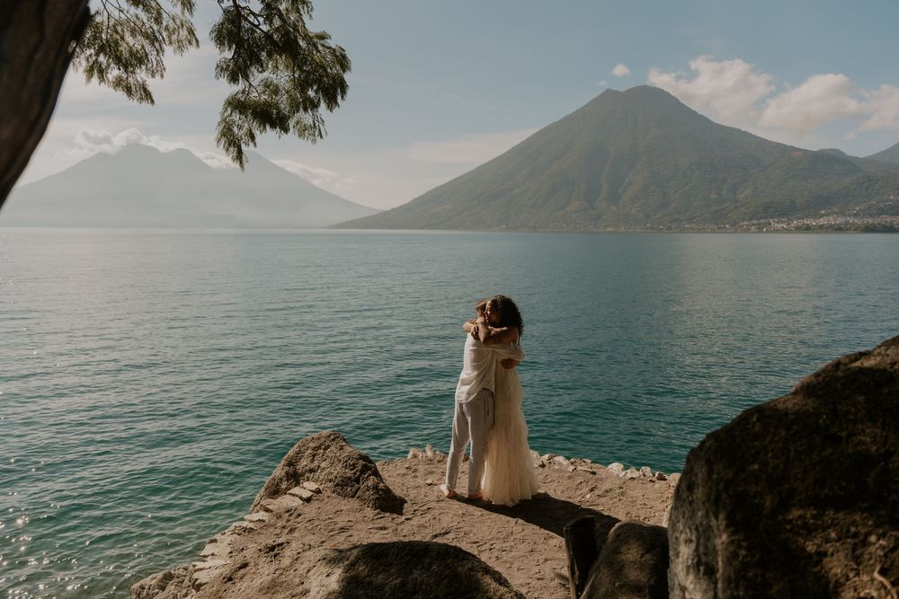 Scenic lakeside views of Lake Atitlan in Guatemala with volcanic mountains rising above turquoise waters.