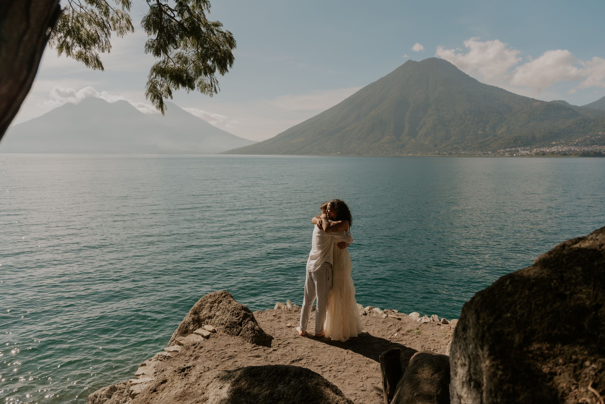 Scenic lakeside views of Lake Atitlan in Guatemala with volcanic mountains rising above turquoise waters.