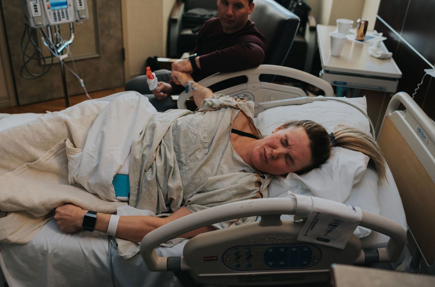 Patient resting in hospital bed while being monitored with medical equipment.