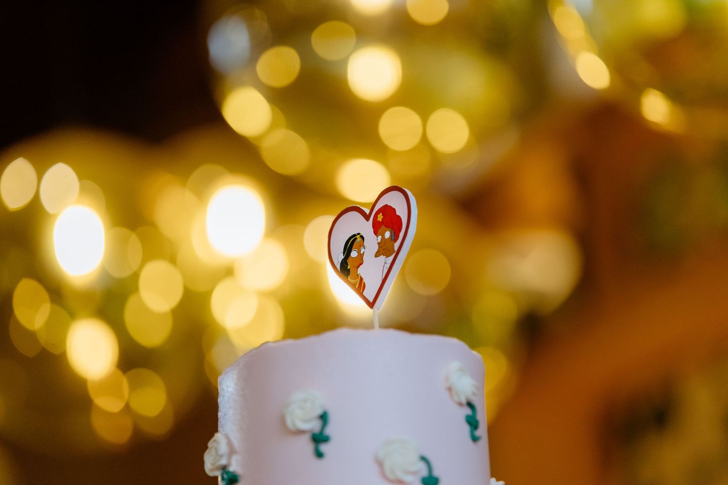 Indian wedding cake with Apu and his wife from The Simpsons as a cake topper