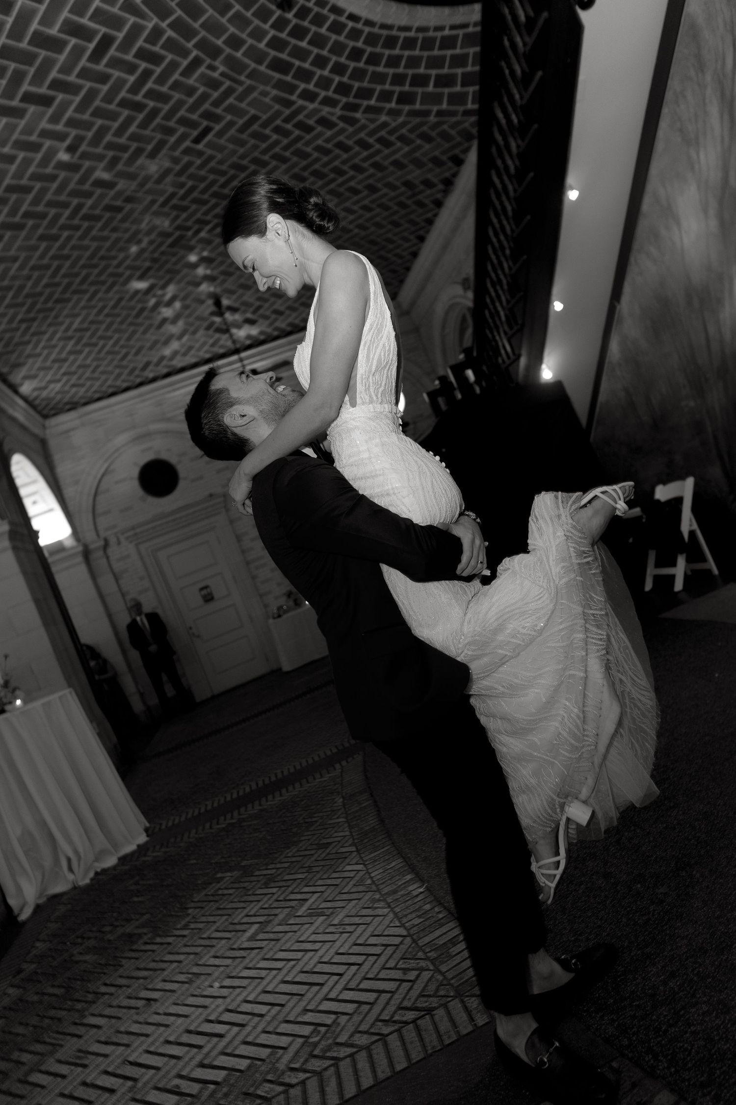 A sequence of black and white dance photos showing energetic movements on a patterned brick floor.