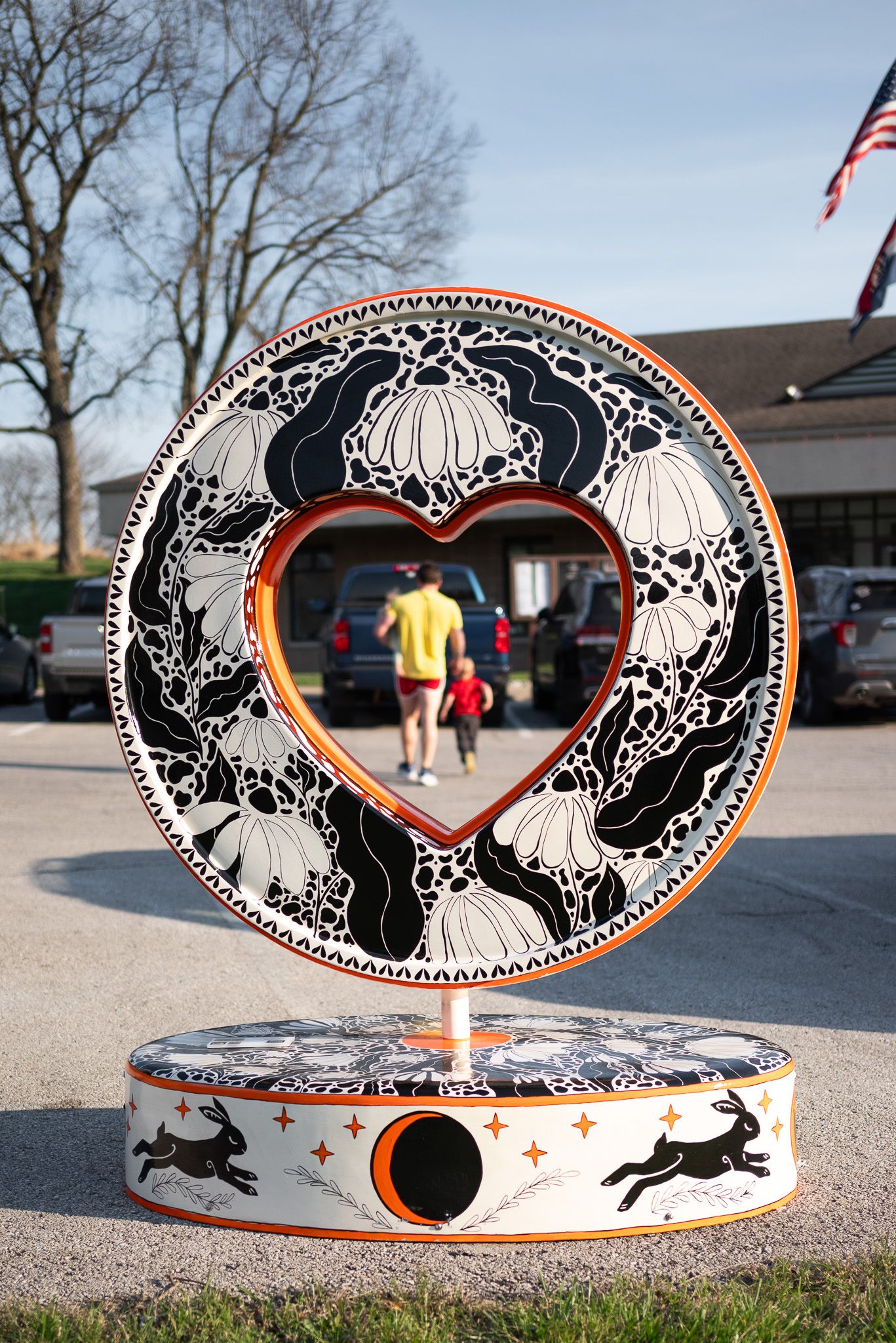Whimsical coneflower and rabbit illustration on Parade of Hearts 2026 sculpture