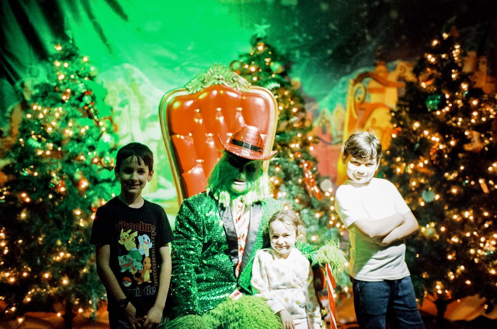 Holiday scene with decorated Christmas trees and colorful lighting effects.