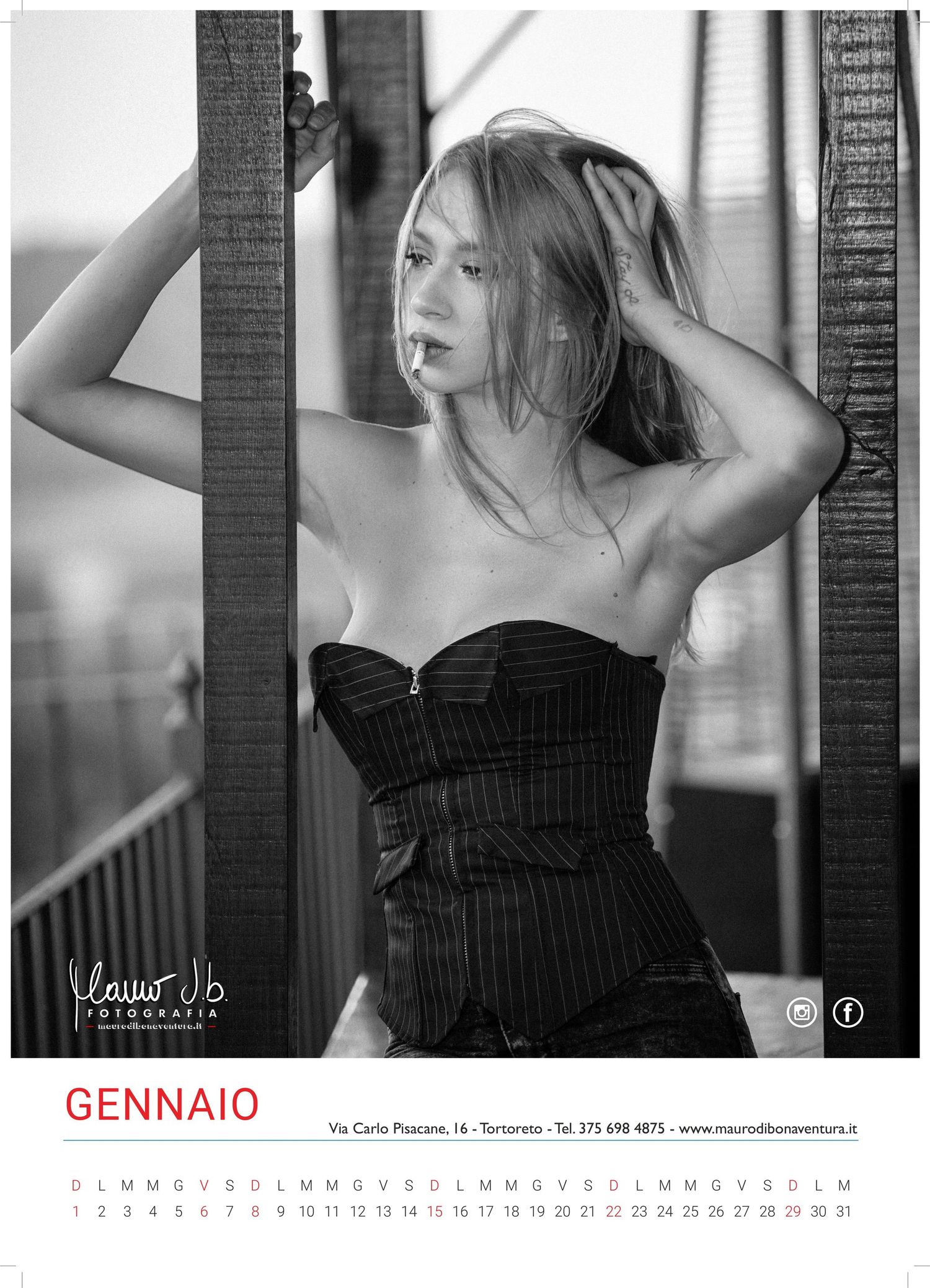 Black and white portrait of model in corset posing with hands in hair for January calendar.