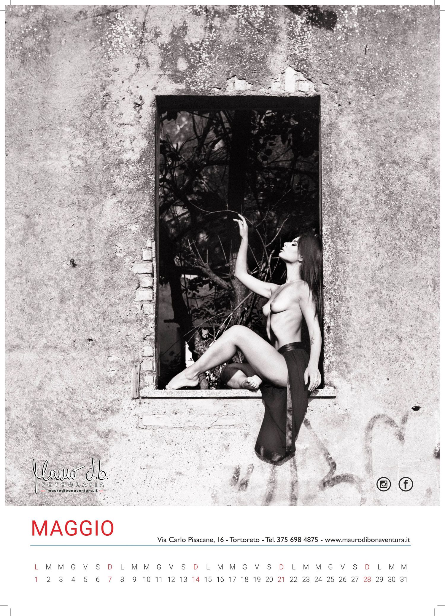 Black and white calendar art photo featuring a figure in a stone window frame.