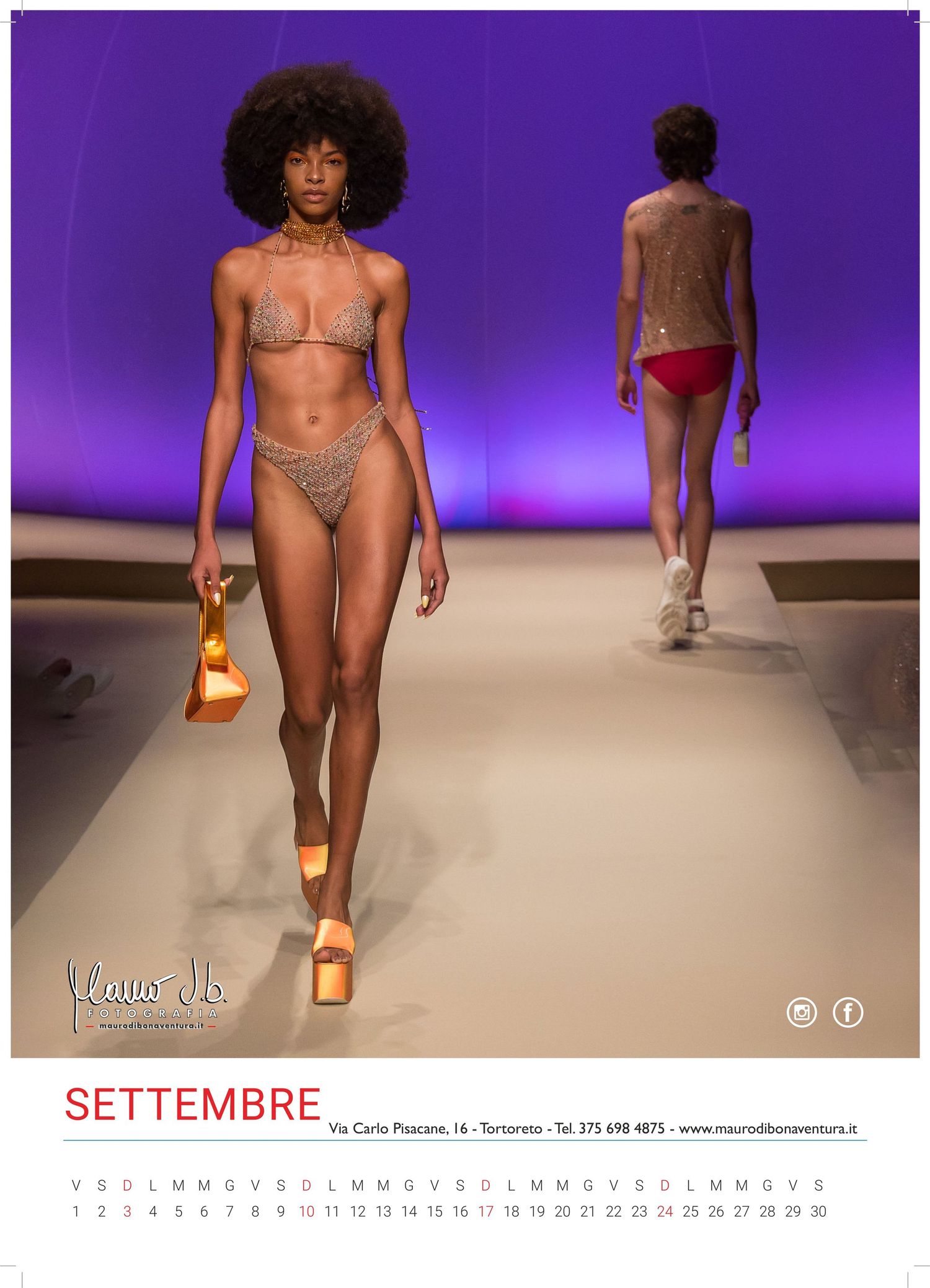 Models walking the runway in swimwear against a purple backdrop.