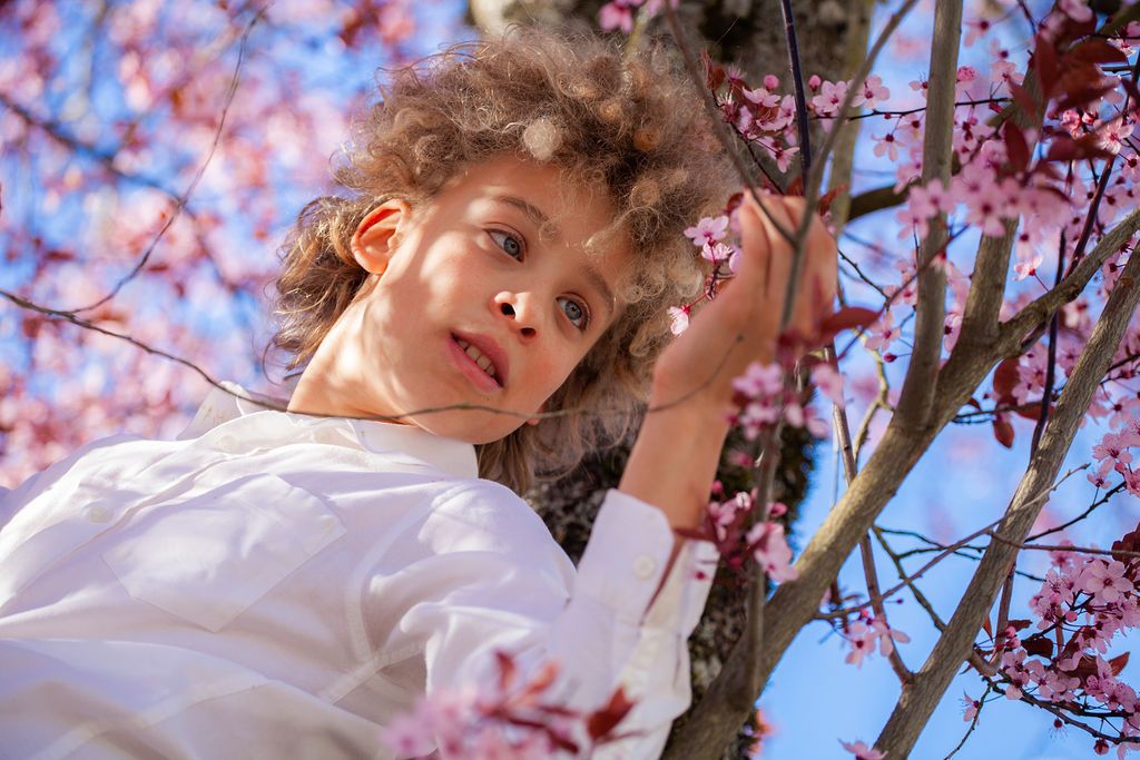 Springtime portrait among blooming cherry blossom branches.