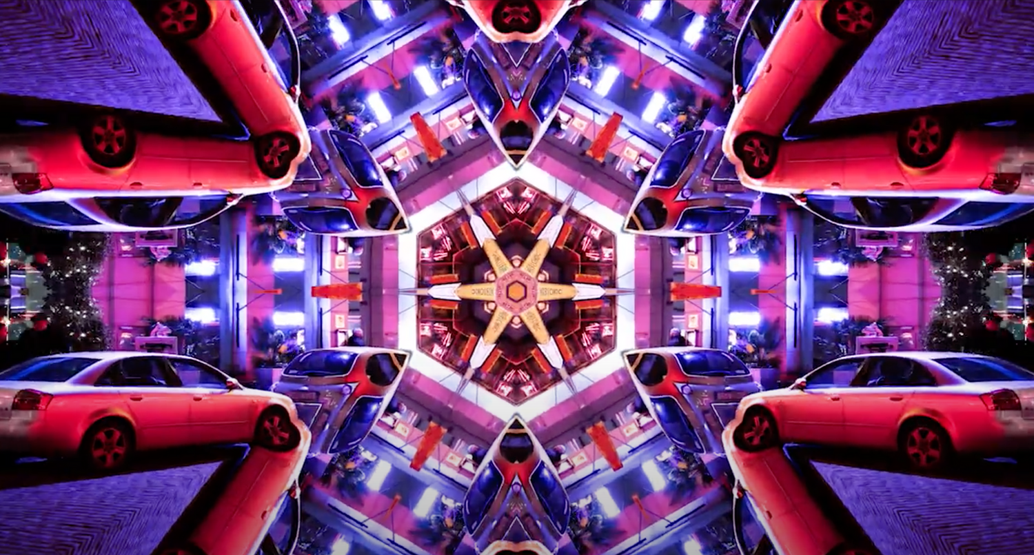Kaleidoscopic abstract photo featuring illuminated red sports cars and neon violet lights in a hexagonal pattern.