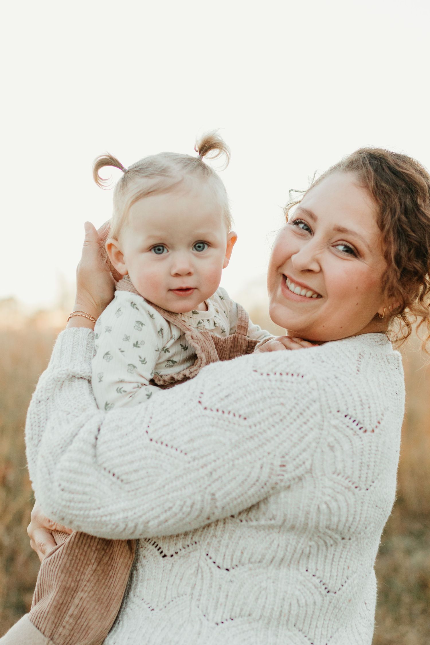 Spartanburg SC Family photographer taking photos in field while boy runs around pretending to be an airplane