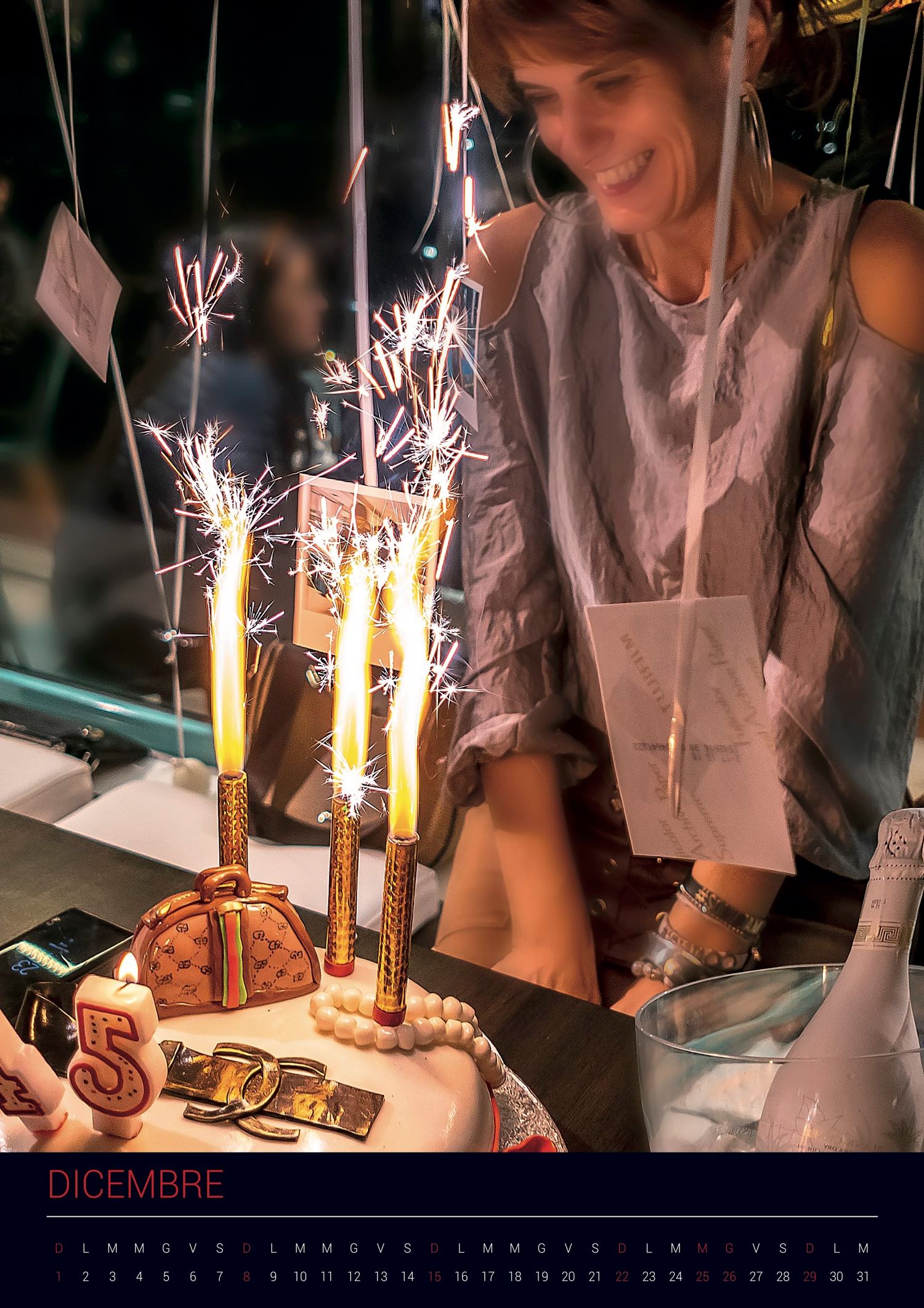 A celebration cake with sparkler candles being lit at a festive gathering in December.
