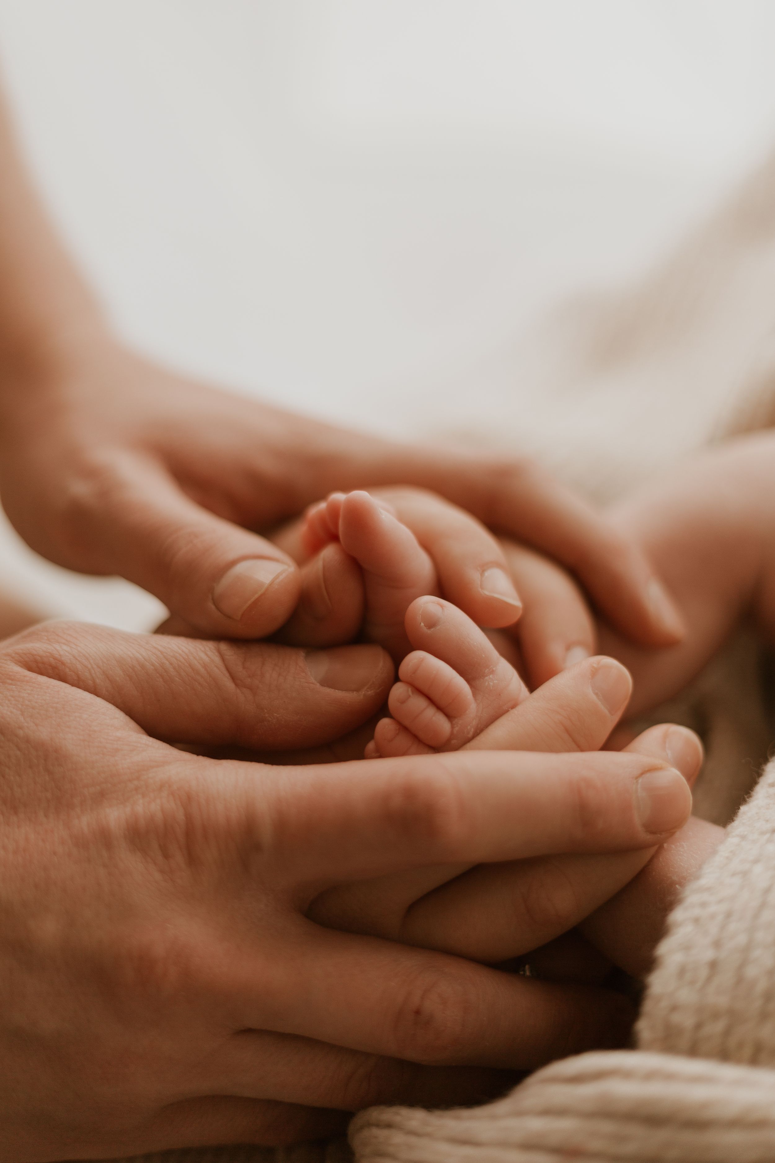 Holding newborn toes