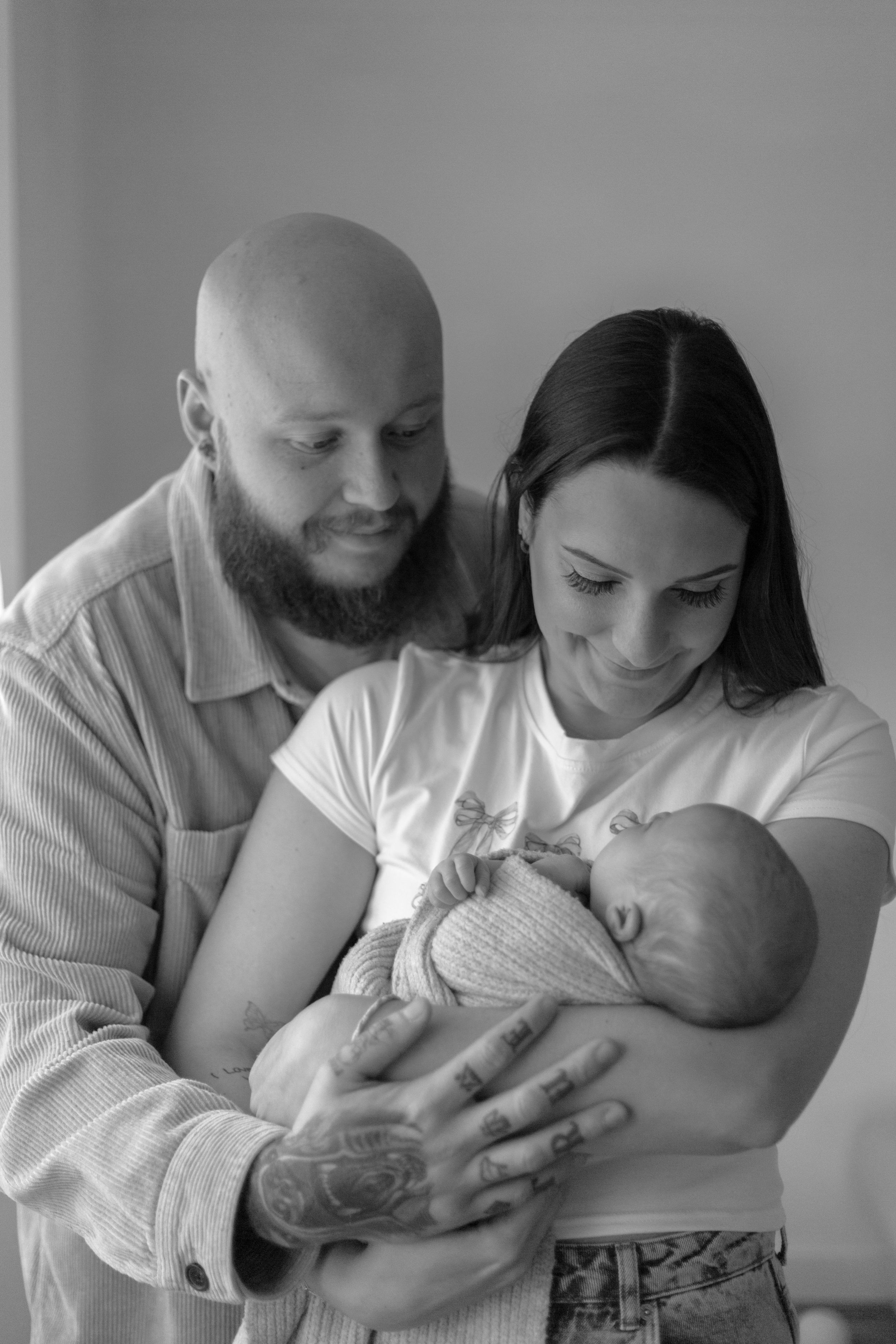 mother and father holding baby