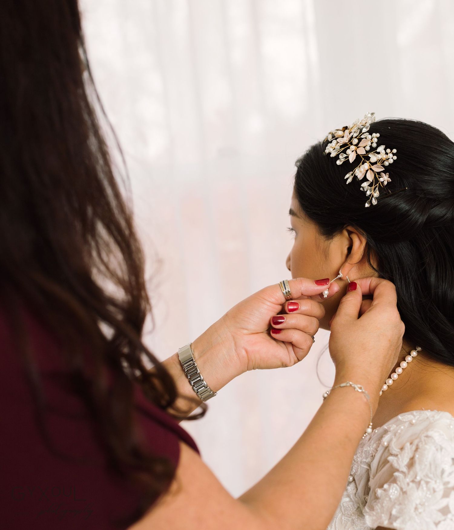 Close up of wedding preparations showing pearl jewelry and sparkly hair accessories.