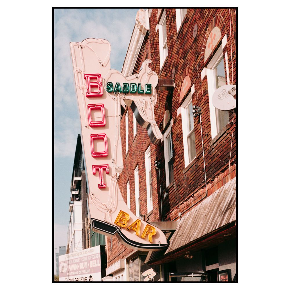 Vintage red neon sign for food establishment on brick building facade with retro styling.