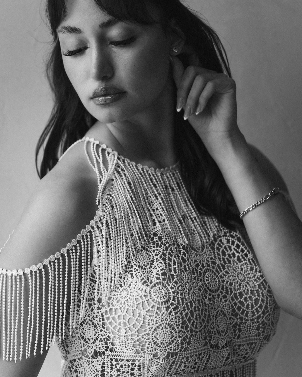 Detail shot of intricate beaded fringe on wedding dress bodice.