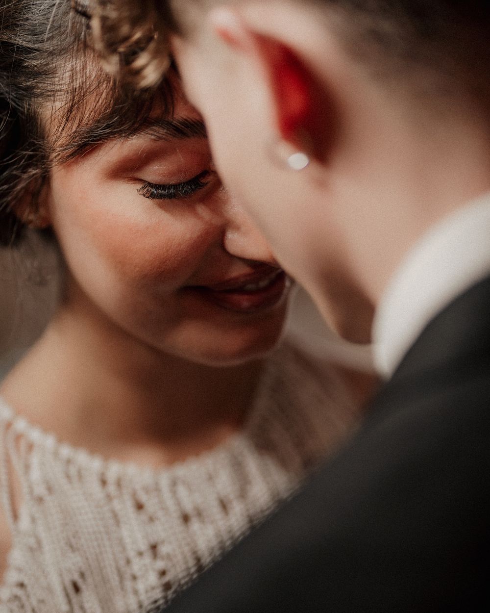 Close-up romantic moment between newlyweds showing tender affection.