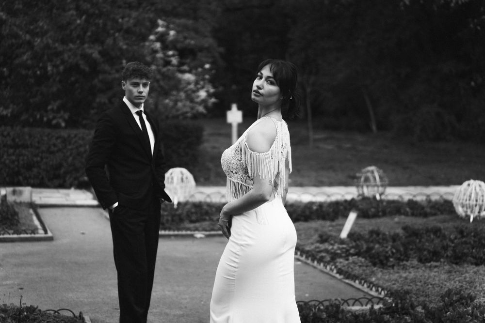 Romantic black and white photo of couple in formal wear on garden terrace. Next day wedding photography.