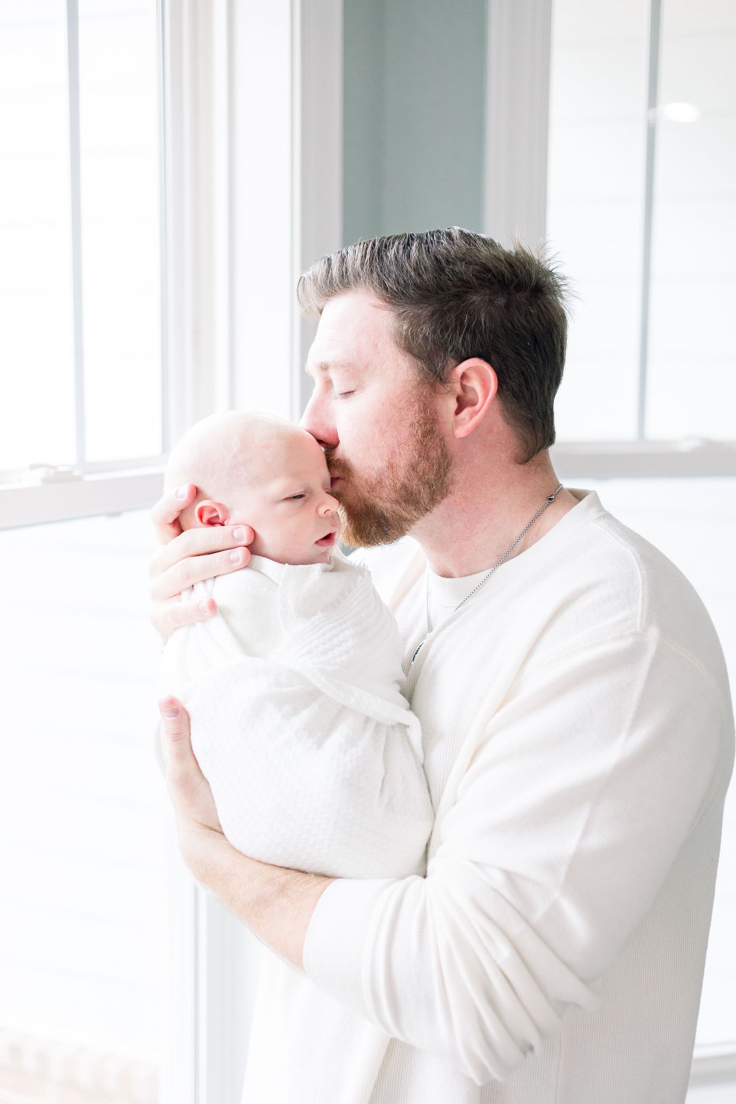 In-home newborn photography session in Augusta GA featuring sleeping baby swaddled in neutral tones