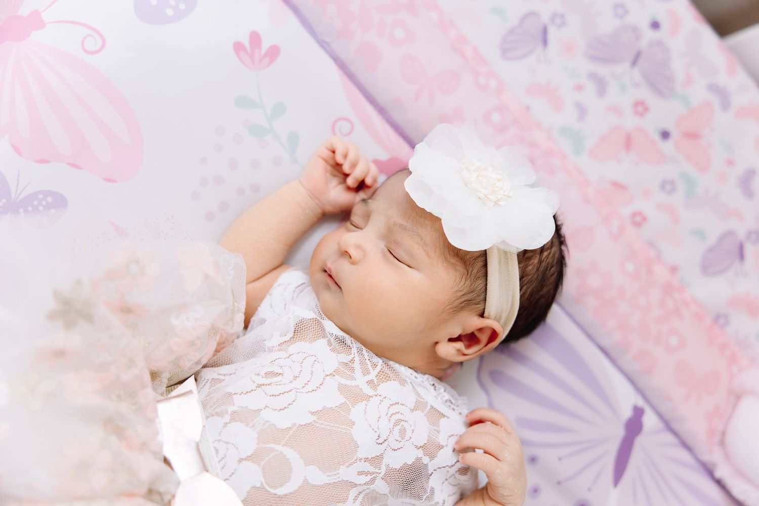 newborn lifestyle photoshoot of baby girl in her crib. Greeley colorado new born photography