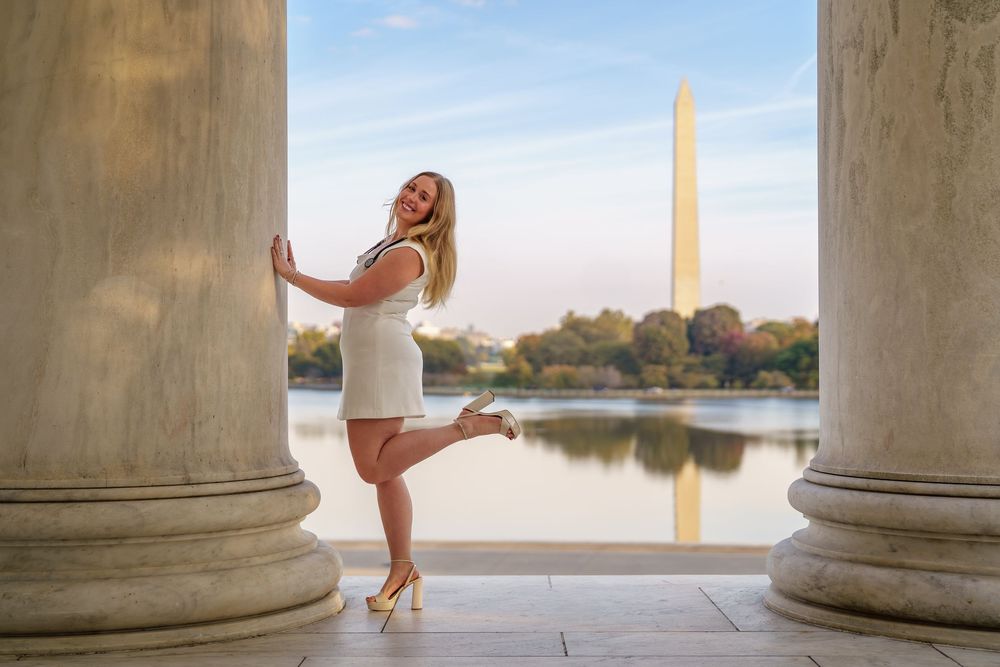 graduate posing at the jefferson memorial, in Washington DC