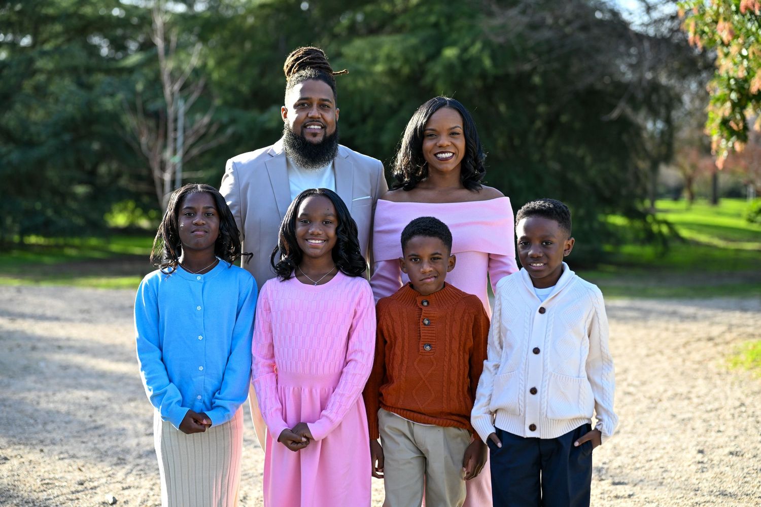 Family portrait series showing group poses outdoors in color-coordinated casual outfits.