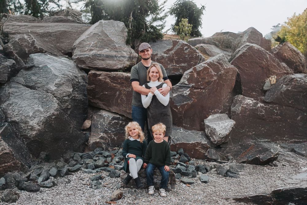 A family of four smiles at the camera at Carpenter Lake in Michigan.