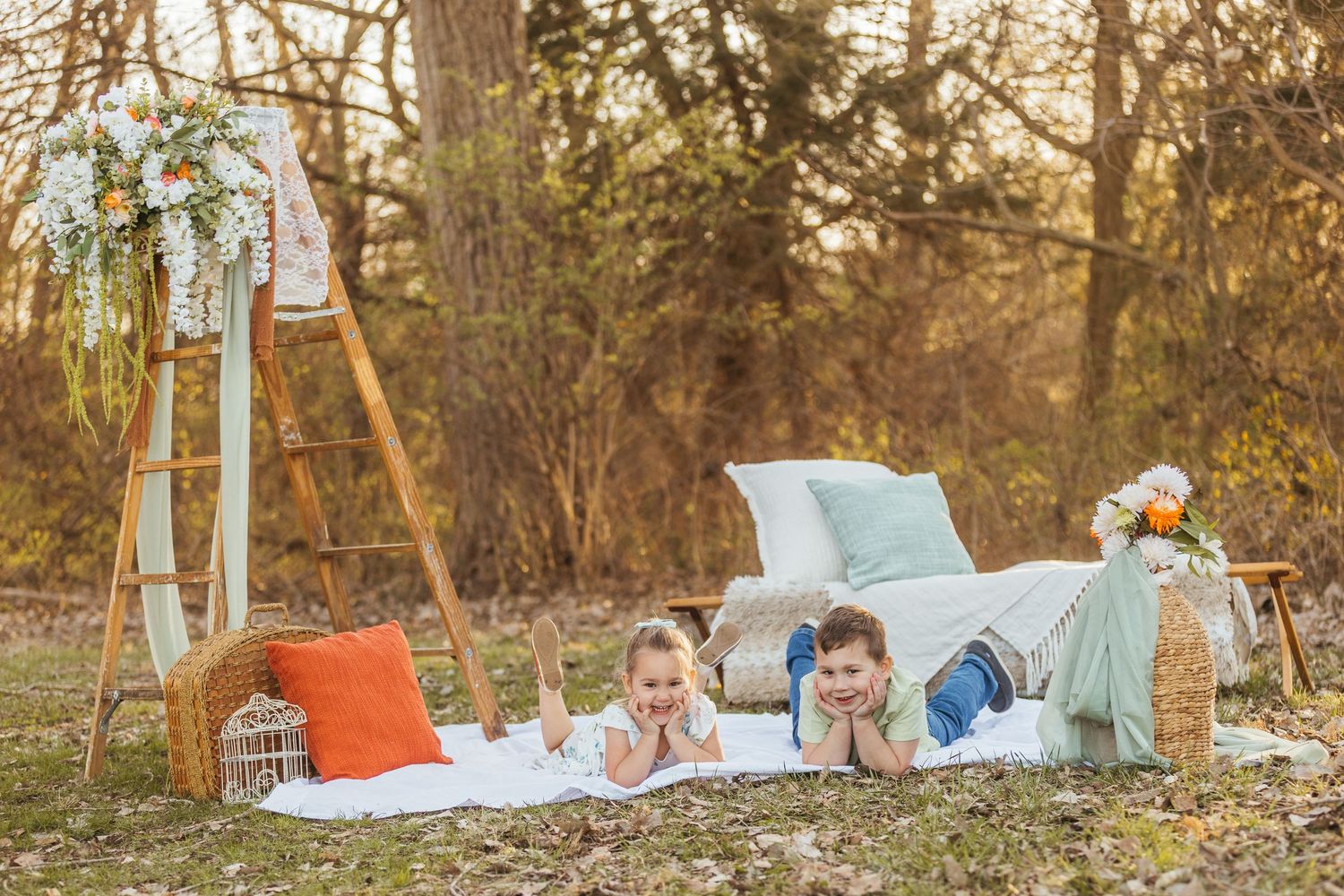 Two young children share a playful hug outdoors with golden bokeh lighting in the background.