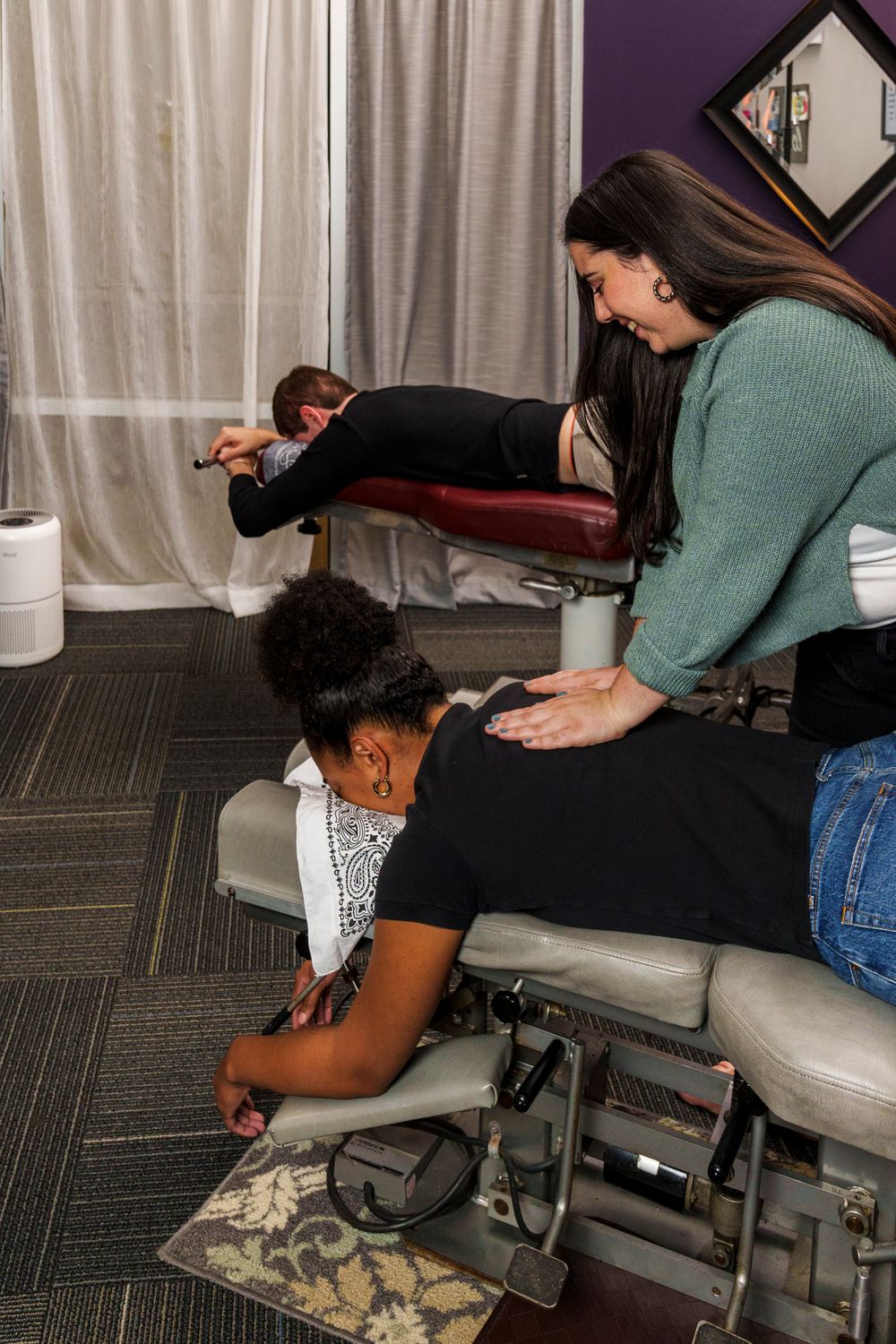 Therapist provides specialized spinal treatment to patient on adjustable medical table.