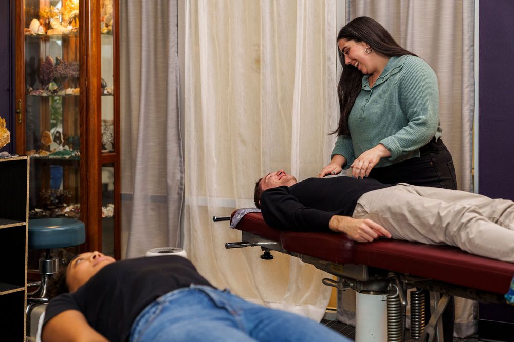 Medical practitioner performs therapeutic adjustments in modern clinical environment.