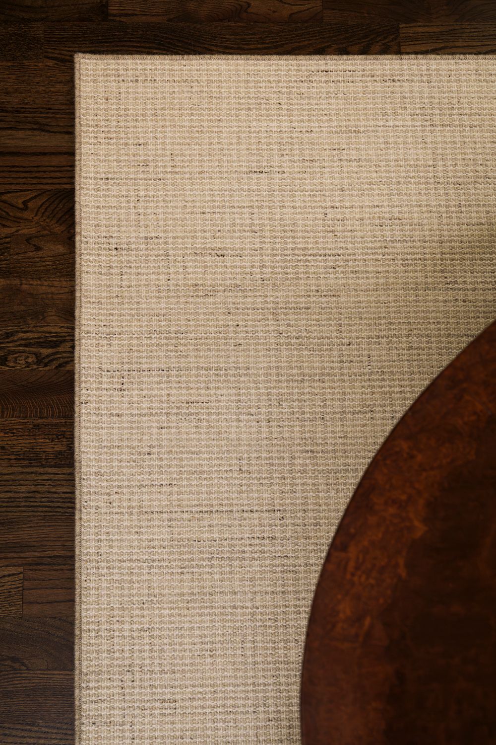 A series of progressively cropped images showing a dark wooden surface meeting textured beige fabric or canvas material.