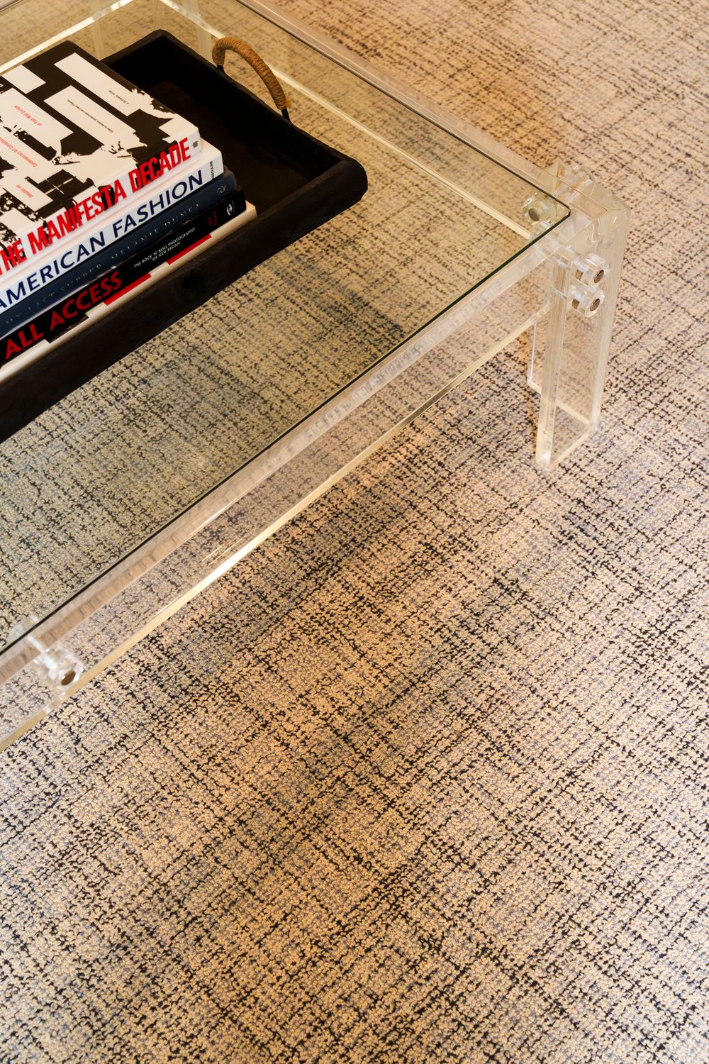 A glass bottle of Altoids mints lies on a textured beige carpet or rug surface.