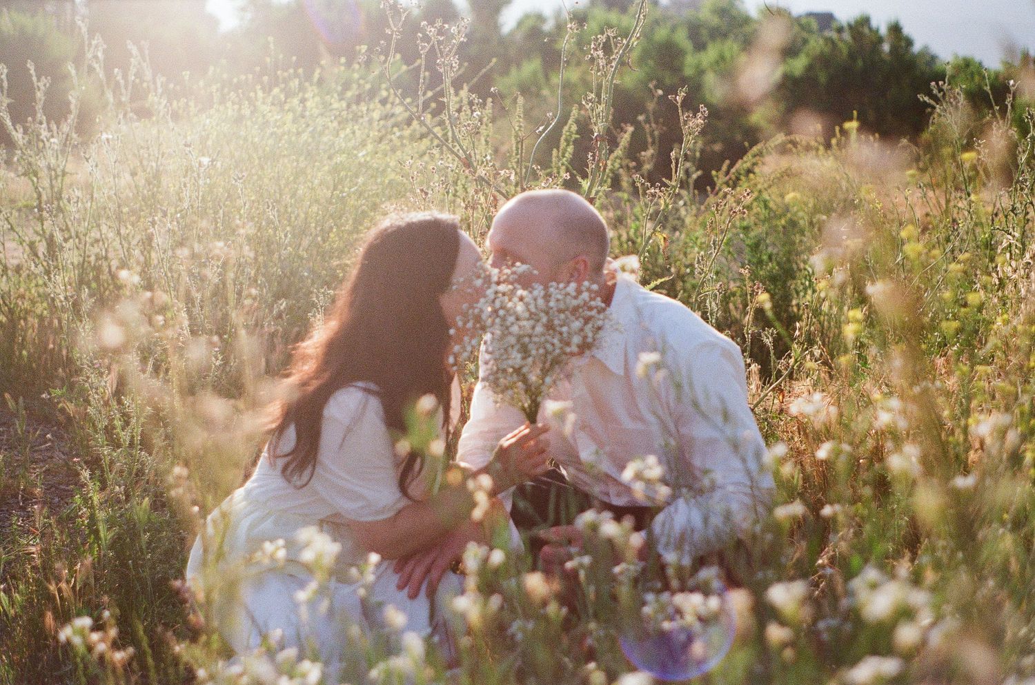 Romantic Ojai engagement photography on film with dramatic mountain views and wild grasses.