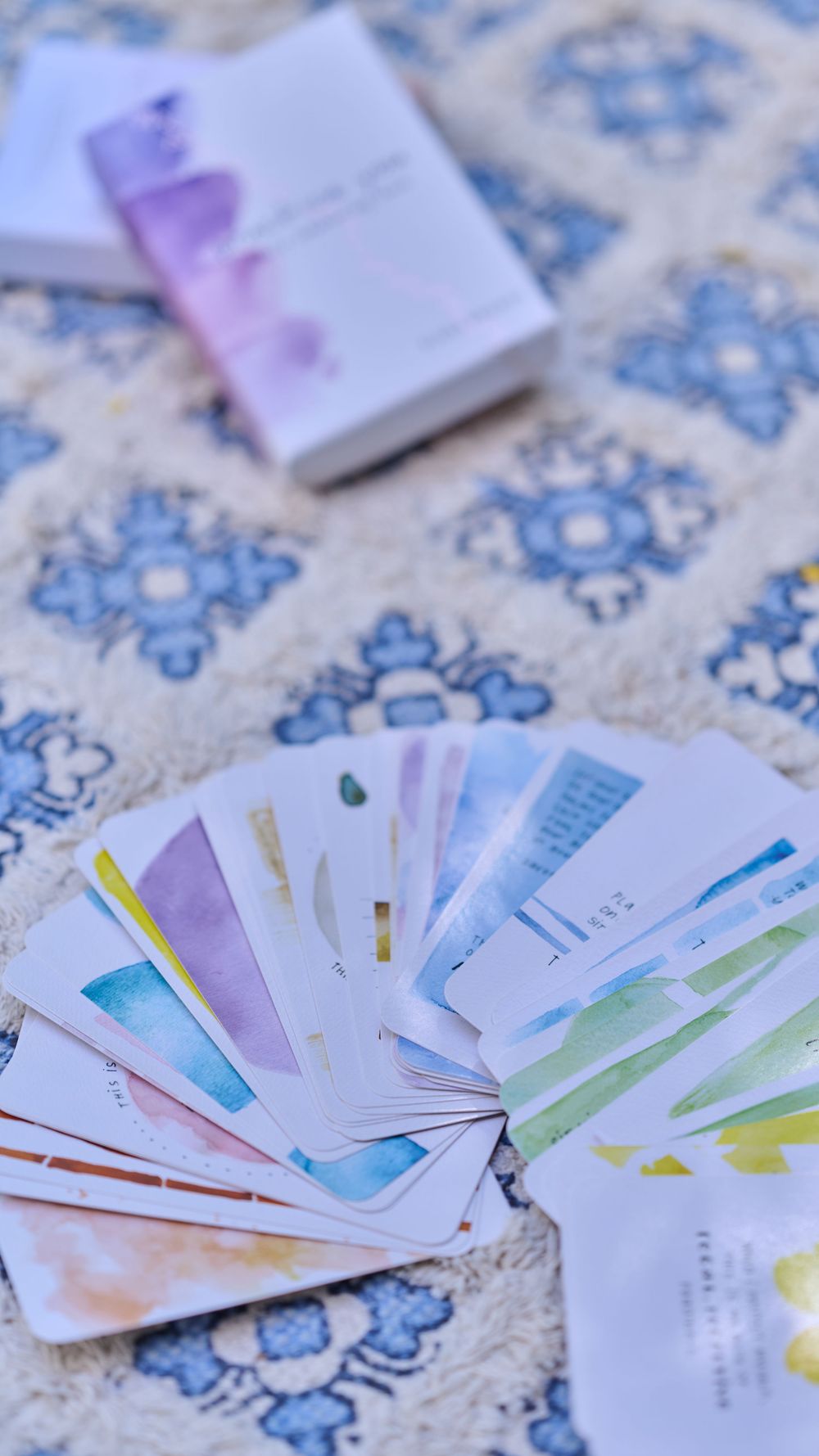 Fanned out colorful paper currency arranged on a blue and white textured surface.