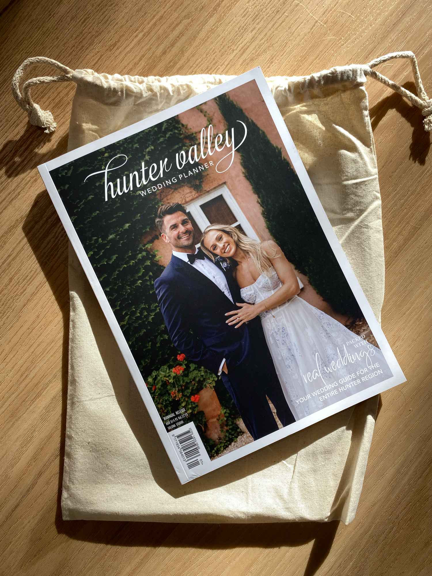 Professional wedding photo album pages showing a couple's special moments printed on thick matte paper with soft lighting.