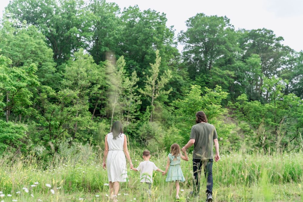 A series of joyful moments captured in a lush green meadow on a sunny summer day in Cleveland Ohio for Family Portrait session