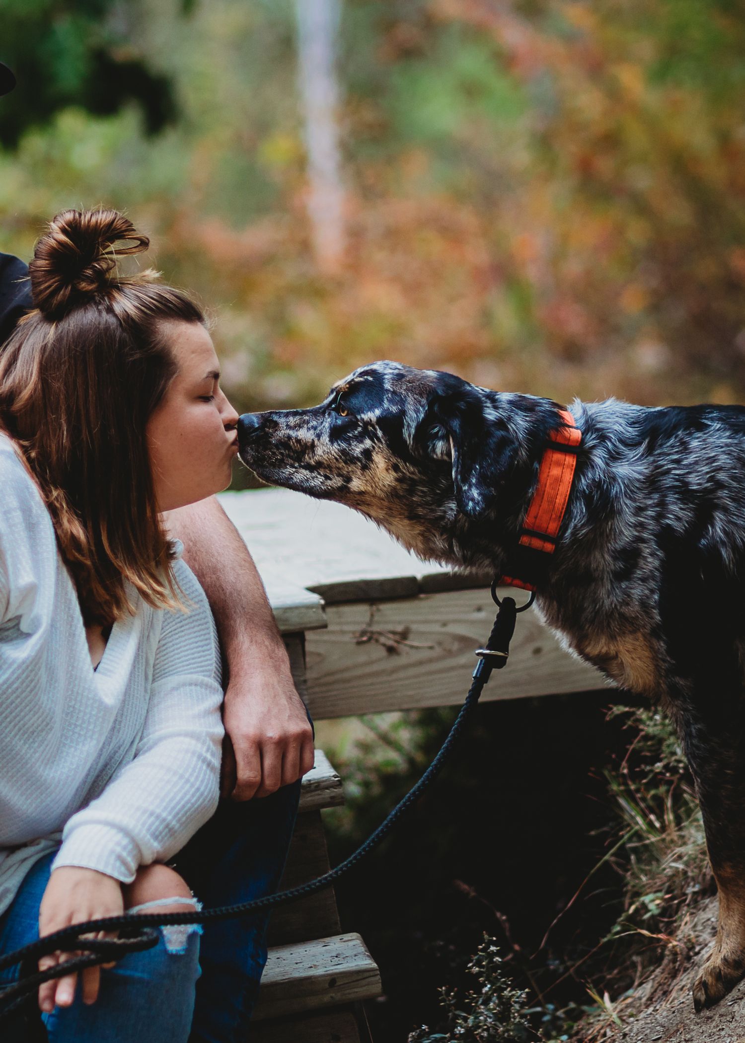 Professional photo of a woman kissing her dog