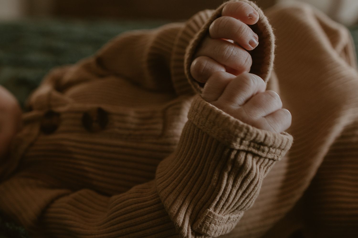 Close-up of newborn hands, capturing delicate details in Oklahoma birth photography, symbolizing new life, connection, and first moments
