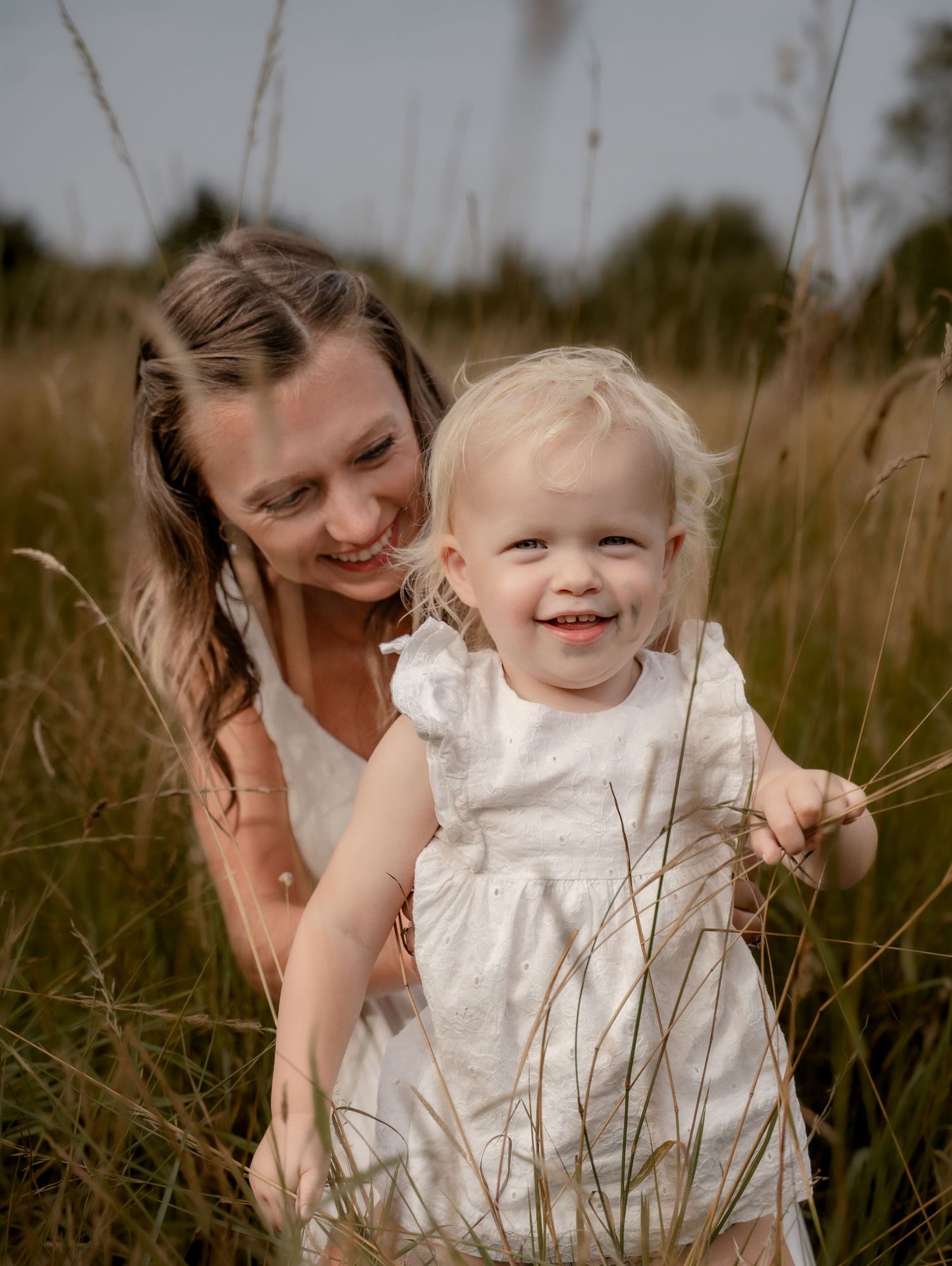 Little girl painting outdoors during a relaxed storytelling motherhood photoshoot in Leicestershire.