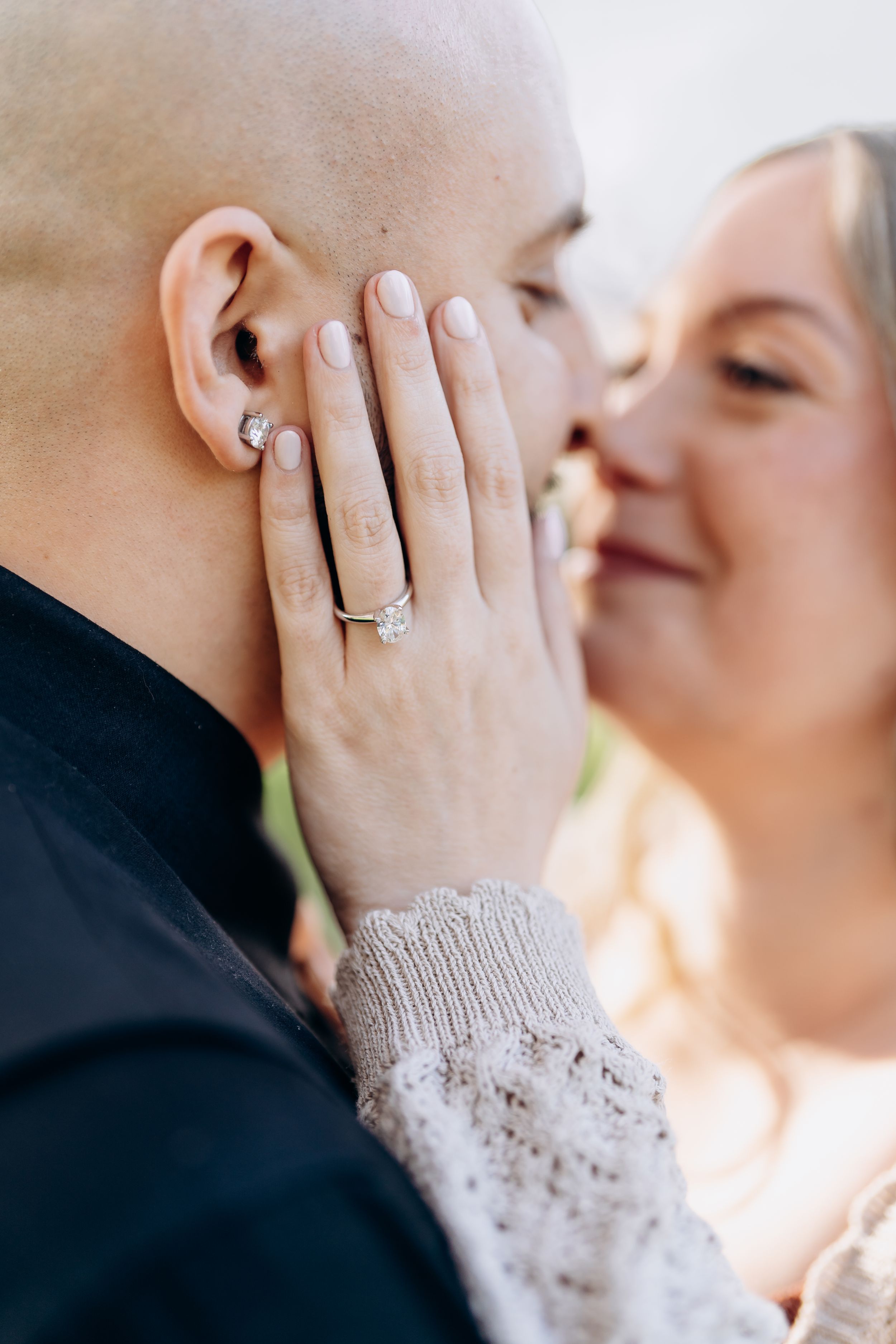 Close-up romantic wedding photos showing engagement ring and intimate moments between newlyweds in soft lighting.