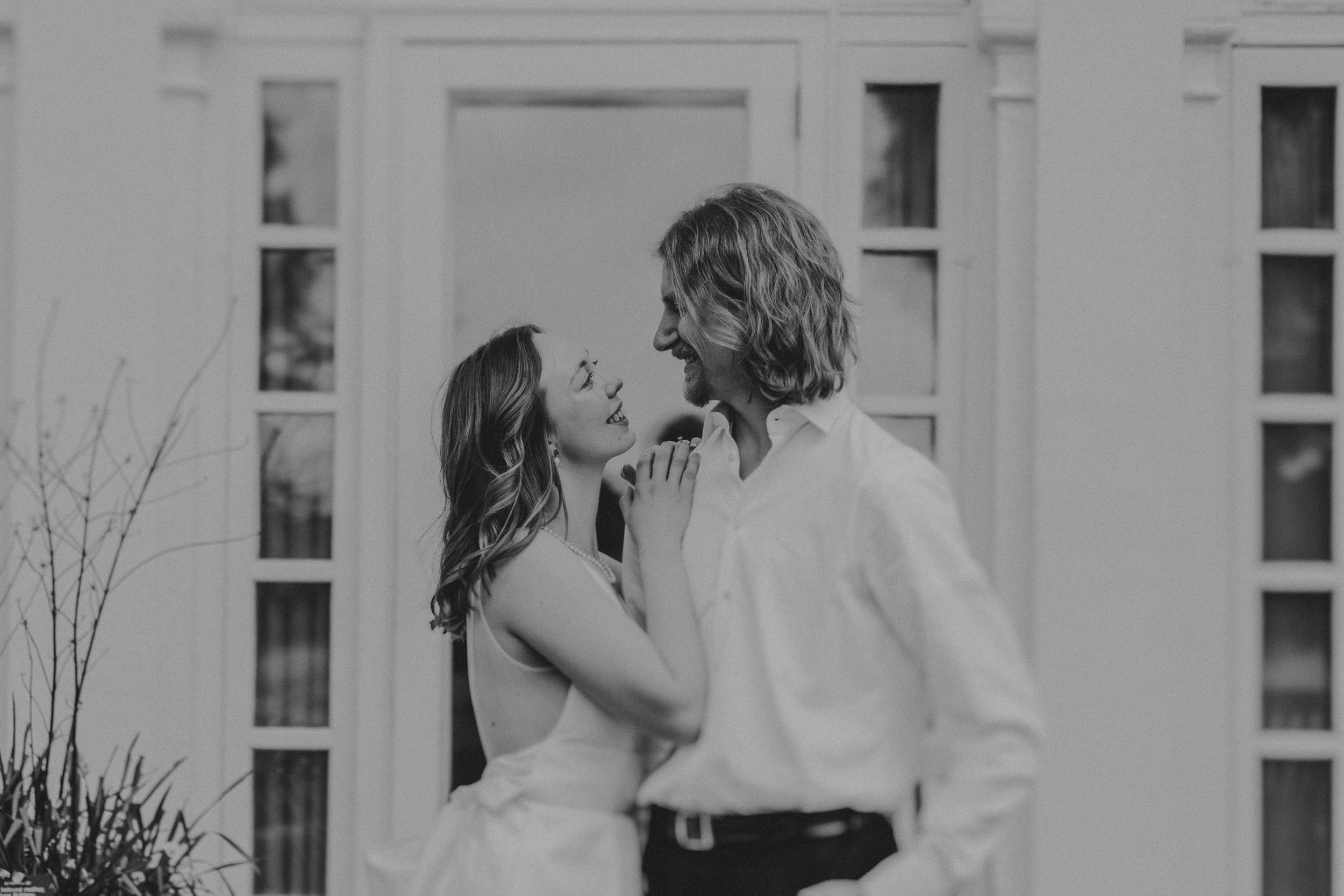 A series of black and white photos showing couples kissing and embracing in romantic outdoor settings.