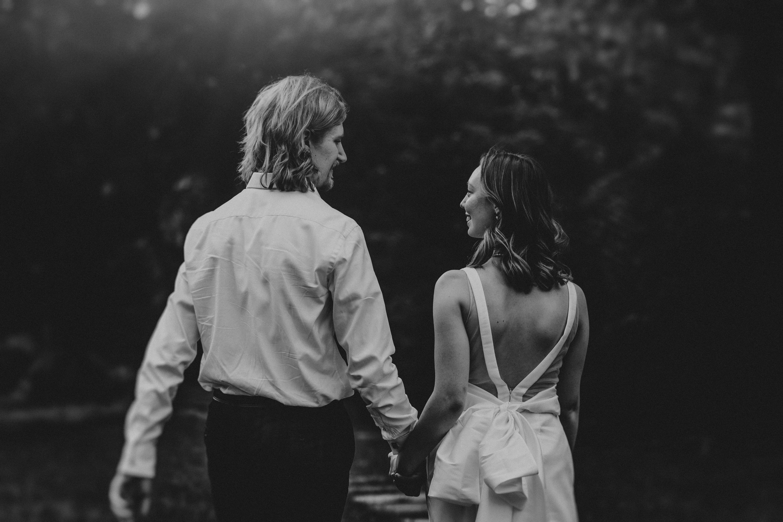 A black and white photo series showing intimate moments between two people walking together in a romantic setting.