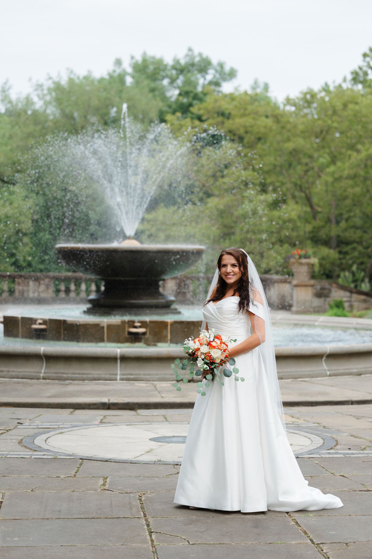 Bride near fountain at Italian Cultural Gardens in Cleveland.