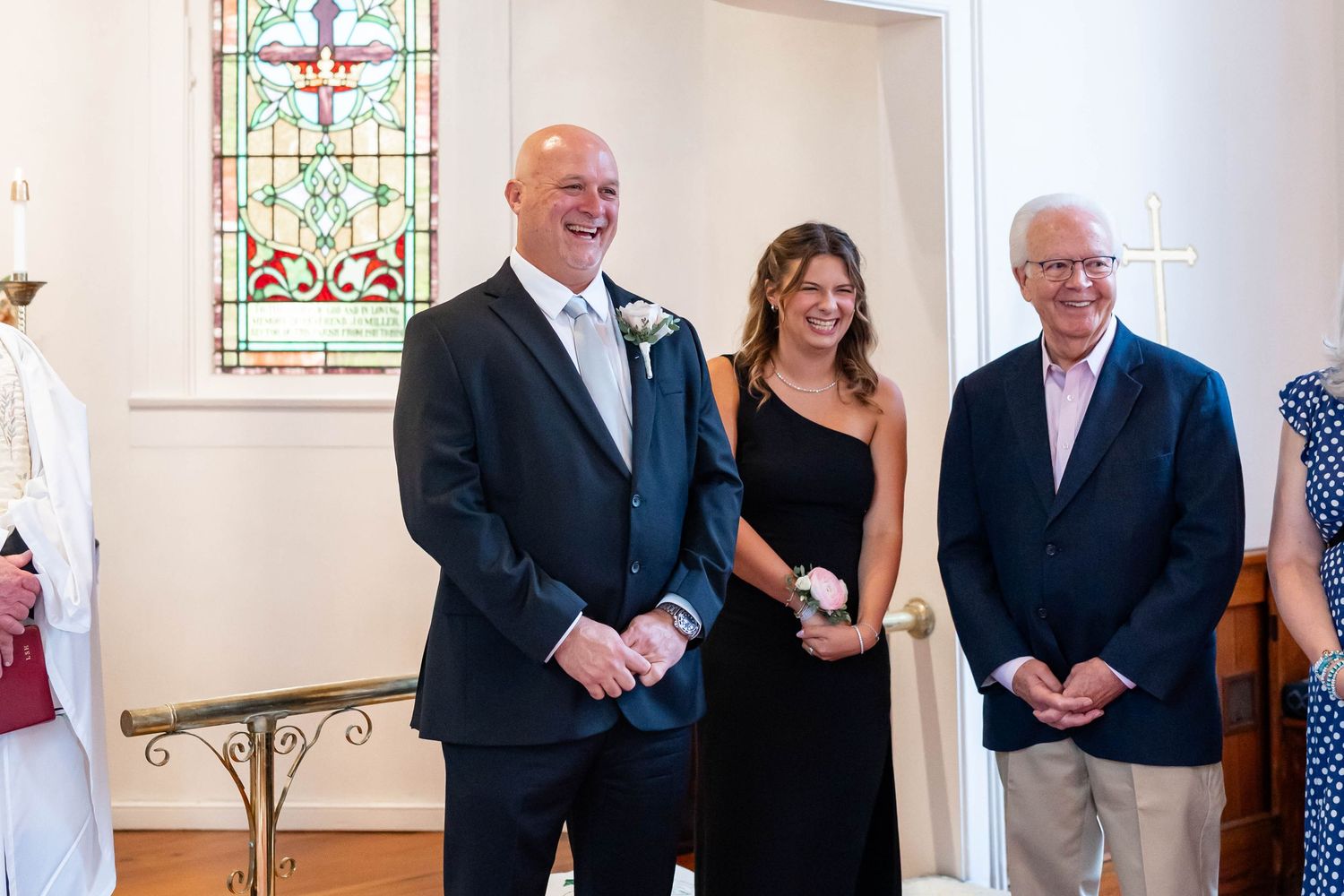 groom smiles at bride as she walks down the aisle