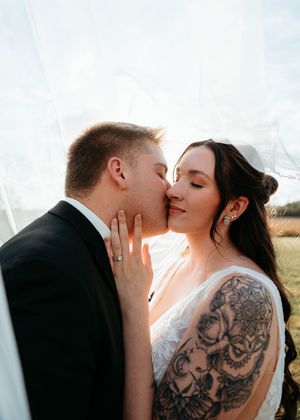 A romantic wedding portrait series showing a couple sharing intimate kisses with a visible back tattoo on the bride.