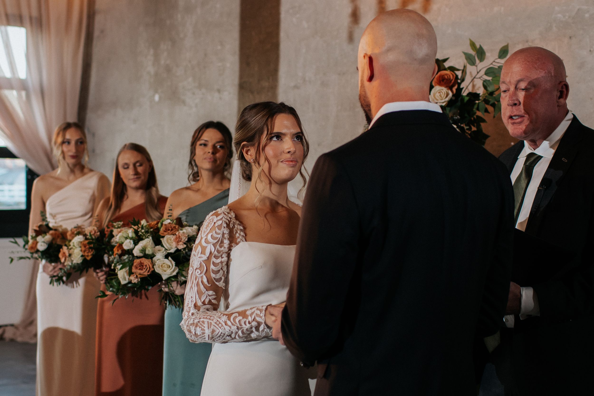 Intimate wedding celebration in an industrial-chic venue with exposed brick walls.